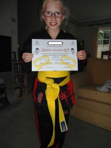 L with her new and well deserved yellow belt and certificate
